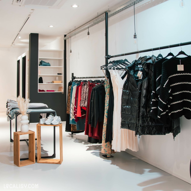 Intérieur du magasin Neo Store à Huy avec une sélection de vêtements streetwear colorés et tendance.