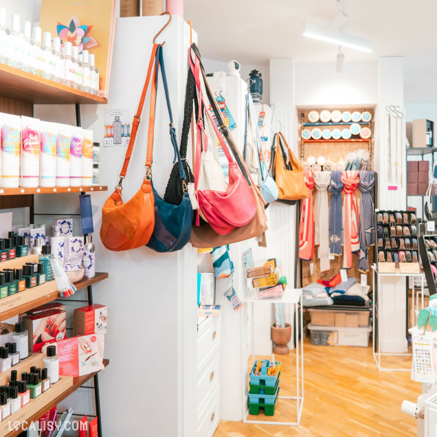 Intérieur du concept store Ultra Bien à Huy, présentant des sacs à main et des produits de beauté.